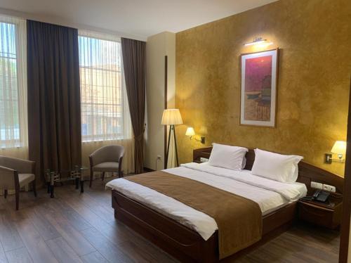 a hotel room with a large bed in a room at Ararat Hotel in Yerevan