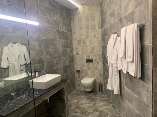 a bathroom with a sink toilet and a mirror at Ararat Hotel in Yerevan