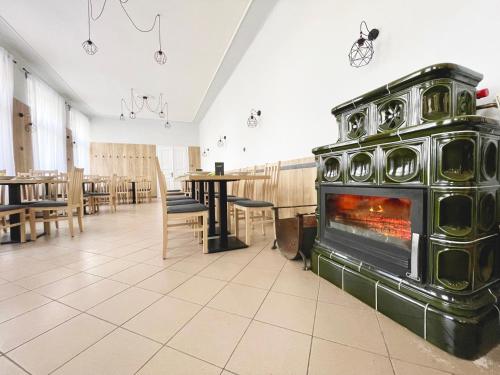 a large fireplace in a room with a restaurant at Penzion U Nováků in Kožlí u Orlíka