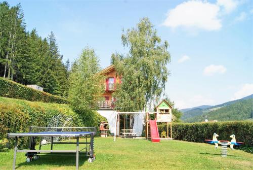 a family playing in the yard of a house at Ferienwohnung in ruhiger Lage- Panorama Terrasse, 2 SZ, rollstuhlfreundlich in Pöllauberg