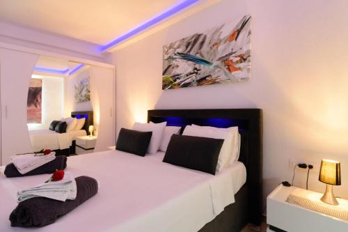a bedroom with a large white bed in a room at Luxury Lake View in Agios Nikolaos