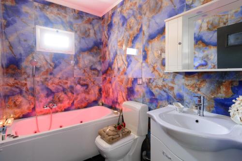 a bathroom with a tub and a sink and a toilet at Luxury Lake View in Agios Nikolaos