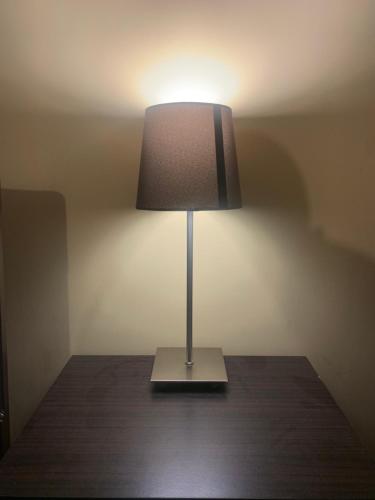 a lamp sitting on top of a wooden table at Cafe Sola bnb in Shillong