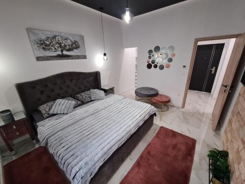a bedroom with a large bed in a white room at Premium class Apartmant - free parking in Zadar