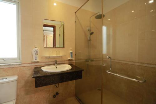a bathroom with a sink and a shower and a toilet at THANH TAI HOTEl 1 in Ho Chi Minh City