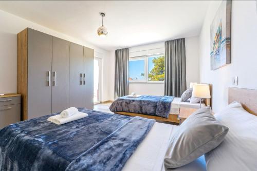a hotel room with two beds and a window at Villa Anita Kožino in Kožino