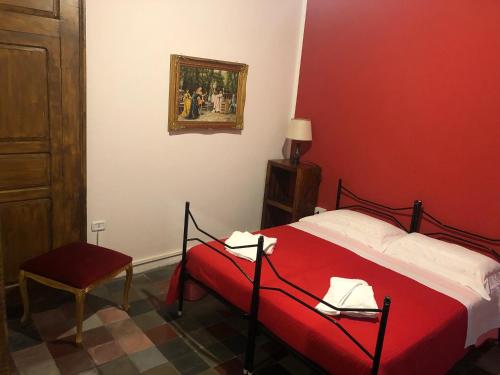 a red bedroom with a bed with a red blanket at Bed and Breakfast Family Palazzo Stillitano Stilo in Stilo