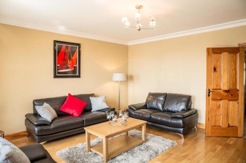 a living room with a couch and a table at Once Upon a Tide in Clifden