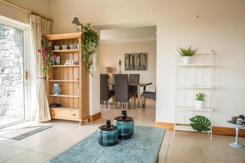 a living room with a table and a dining room at Once Upon a Tide in Clifden