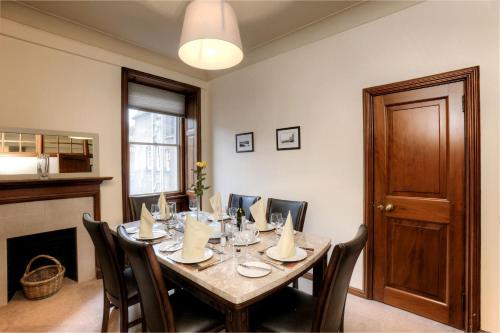 a dining room with a table and some chairs at Argyll Mansions in Oban