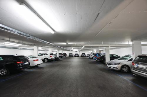 a parking lot filled with lots of parked cars at Altstadt Hotel Hofwirt Salzburg in Salzburg