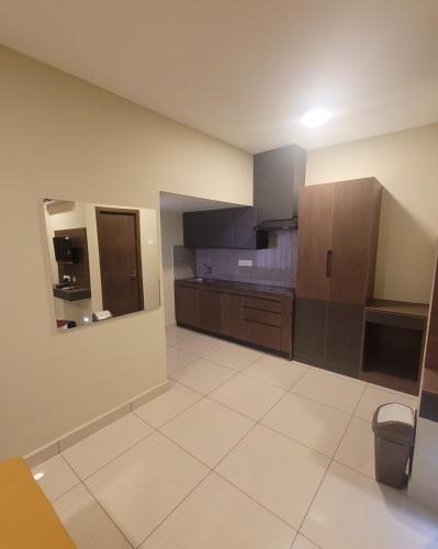 a large kitchen with brown cabinets and a tile floor at M Square in Vellore