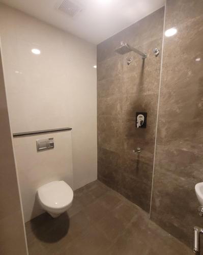 a bathroom with a toilet and a shower at M Square in Vellore