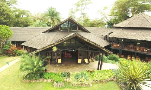 a large house with a large roof at Ol Tukai Lodge Amboseli in Amboseli