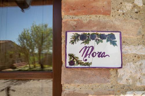 a sign that says mom hanging on a brick wall at Podere Sant'Antonio in Asciano