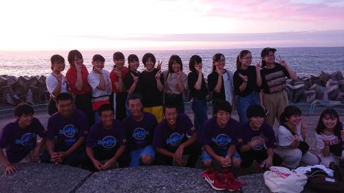 a group of people posing for a picture near the ocean at Live Cafe Hisui no Umi in Itoigawa