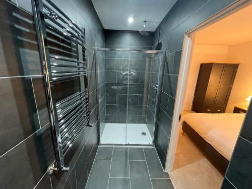 a bathroom with a shower with a glass door at Beautiful House Located Near Kielder Reservoir in Kielder