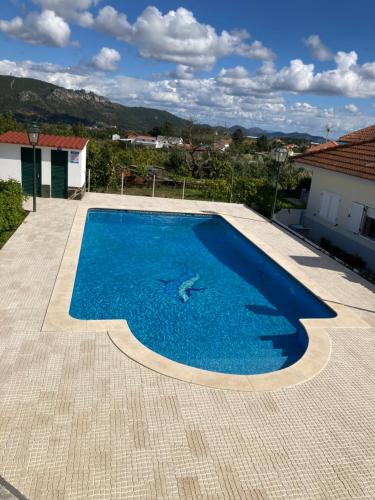 a swimming pool on a roof of a house at Monte das Cerejas in Montes da Senhora