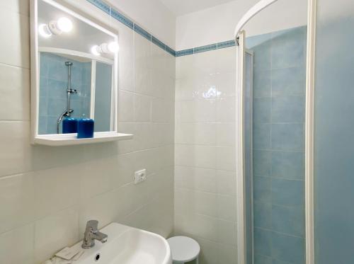 a bathroom with a sink and a toilet and a mirror at Viadeibanchi in Riomaggiore