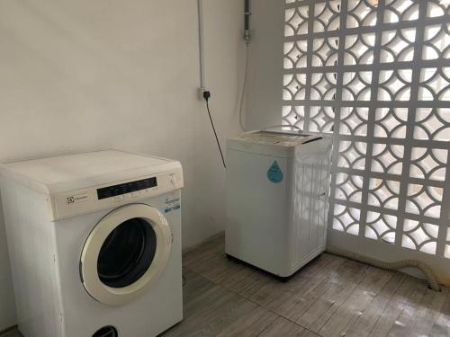 a washing machine and a washer in a room at D’lina pelangi in Kemaman