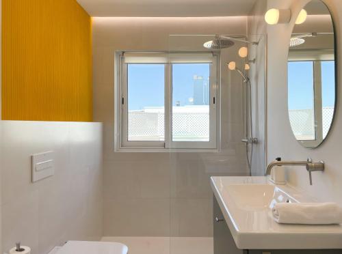 La salle de bains est pourvue d'un lavabo et d'un miroir. dans l'établissement INFINITY Sunny Home by Cadiz4Rentals, à Cadix