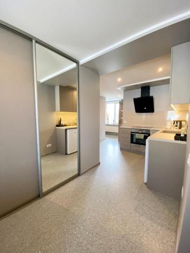a large mirror in a room with a kitchen at Apartments in Dobele city center - Pilsētas Māja in Dobele