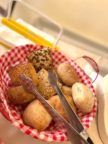 a basket of different types of food with a pair of scissors at Poggio Degli Olivi in Monsummano