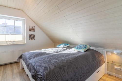 a bedroom with a bed in a attic at Ferienhaus Alana in Hooksiel