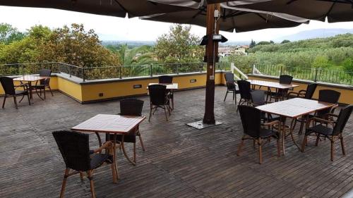 a group of tables and chairs on a deck at Poggio Degli Olivi in Monsummano