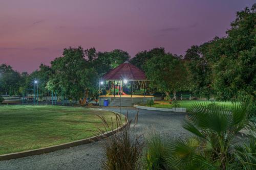 a pavilion in a park at night at Sterling Gir in Sasan Gir
