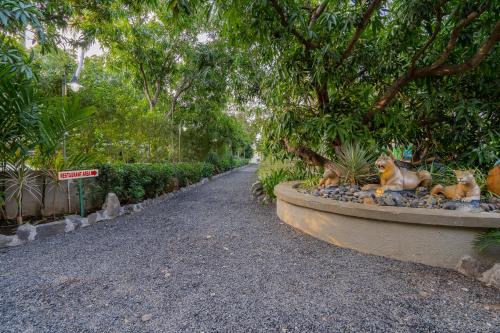 a garden with statues of animals sitting in a park at Sterling Gir in Sasan Gir