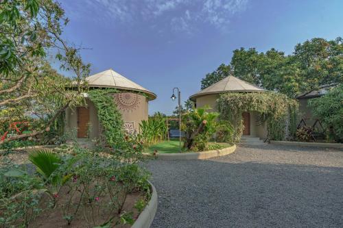 a garden with two gazebos and flowers at Sterling Gir in Sasan Gir
