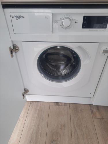 a washing machine with its door open at SUN HOME in Palanga