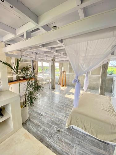 a bedroom with a bed with a canopy at Uluwatu Penthouse in Uluwatu