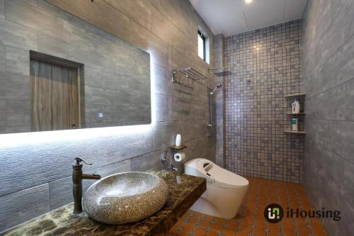 a bathroom with a sink and a toilet at Private Pool Platinum House Melaka By I Housing in Melaka