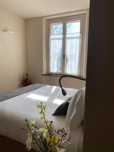 a bedroom with a white bed with a window at Tenuta Pizzone Wine Resort in Rivanazzano