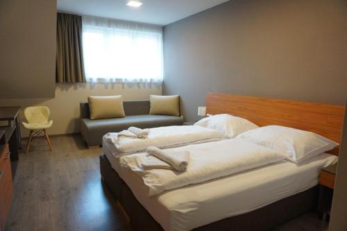 מיטה או מיטות בחדר ב-Centro Panzió