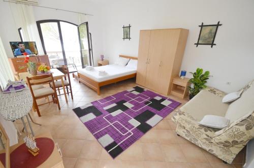 a living room with a purple and black rug at Apartments Blue Lagoon in Kotor