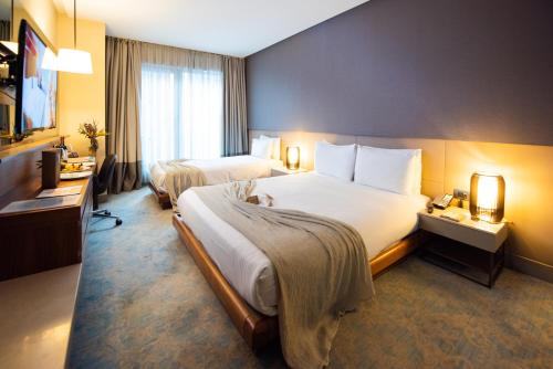 Dosso Dossi Hotels & SPA Downtownにあるベッド