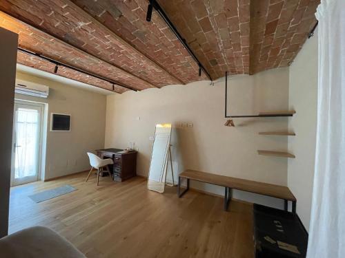 a living room with a brick ceiling and a desk at Tenuta Pizzone Wine Resort in Rivanazzano