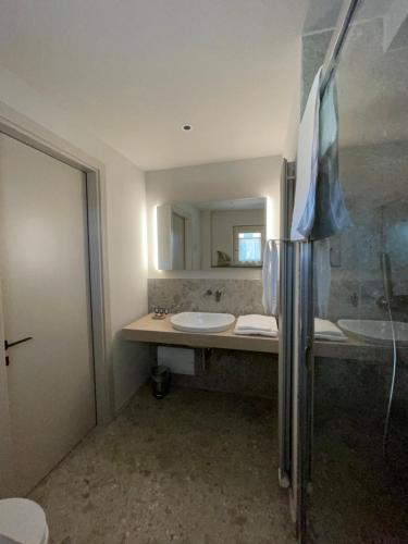 a bathroom with two sinks and a mirror at Tenuta Pizzone Wine Resort in Rivanazzano
