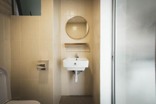 a bathroom with a sink and a mirror at ITCC Manhattan Suites by Calvin in Donggongon