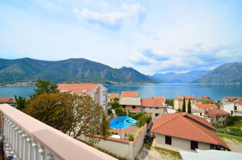 a view of a town with a lake and mountains at Apartments Blue Lagoon in Kotor