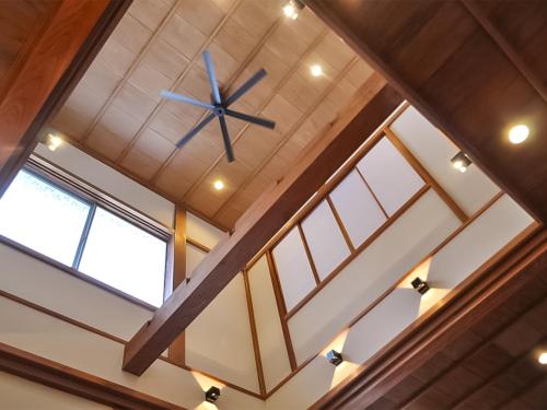 a clock hanging from the ceiling of a building at Guest House Takazuri-KITA in Nanto