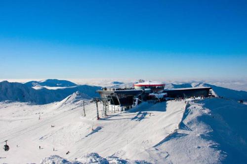 a ski lodge on top of a snow covered mountain at Holiday house Liptovský Ján in Liptovský Ján