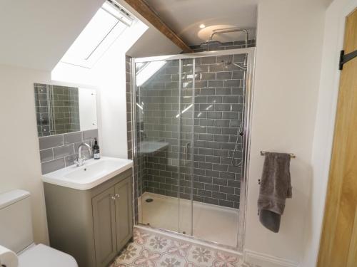 a bathroom with a shower and a sink at The Old Piggery in Worcester