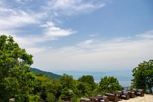 a view from the top of a mountain with benches at Manthos Mountain Resort & Spa in Chania