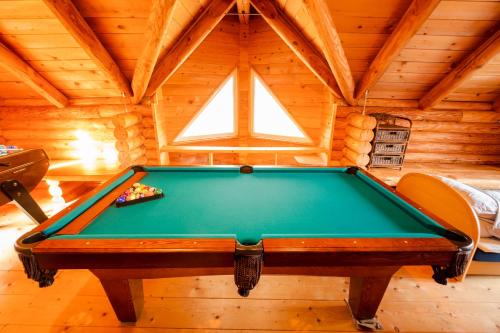 a pool table in a room in a log cabin at Lake Toya Hillside House in Lake Toya