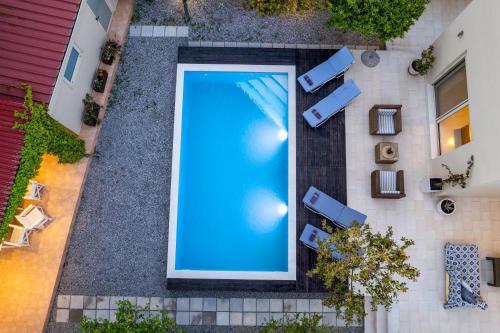 an overhead view of a swimming pool in a building at Vasiliki Villa in Ialysos