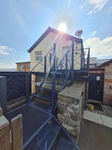 a house sitting on top of a roof at Perfect Location 2 BR serviced apartment Nr Bike Park Wales & Brecon Beacons in Merthyr Tydfil